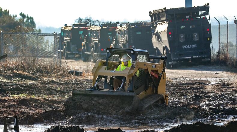 February 6, 2023 Atlanta Law enforcement was out en masse Monday morning, Feb. 6, 2023 at the site of Atlanta’s proposed public safety training center, clearing the woods in anticipation of construction on the controversial facility beginning in earnest. SWAT teams from the Atlanta, DeKalb County police departments, as well as Georgia State Patrol troopers and representatives from other agencies, were seen at the site in southwest DeKalb County. Construction contractors were also there with equipment. Amid the beeping of trucks backing up and the clanging of heavy equipment off Key Road, construction workers busily prepared the site with a backhoe and a bulldozer. Police officers in olive green uniforms patrolled the area atop all-terrain vehicles. The operation was taking place several days after officials announced that initial land disturbance permits had been approved for the $90-million facility — and about three weeks after a similar clearing operation resulted in the death of 26-year-old Manuel “Tortuguita” Teran. During that fatal Jan. 18 incident, Teran is accused of firing at troopers “without warning,” wounding one. Teran died after several other troopers returned fire, the Georgia Bureau of Investigation has said. (John Spink / John.Spink@ajc.com)