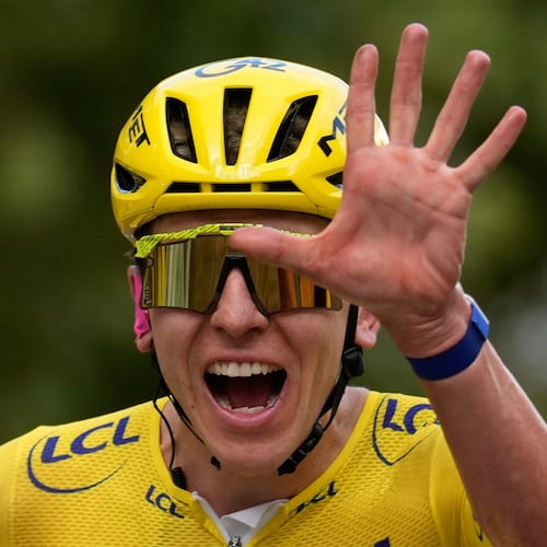 Slovenia's Tadej Pogacar, wearing the overall leader's yellow jersey, celebrates as he crosses the finish line of the last stage of the Tour de France cycling race with start and finish in Paris, Sunday, July 26, 2026. (AP Photo/Mosa'ab Elshamy)