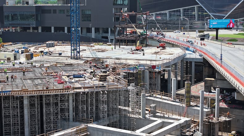 Photo shows new steel structure at Centennial Yards construction site during the Cosm Atlanta Steel Rising Ceremony, Thursday, May 15, 2025, in Atlanta. In the shadows of Mercedes-Benz Stadium and State Farm Arena, a new steel structure is rising, one that is expected to be the anchor of Centennial Yards. Construction started this week, but instead of a groundbreaking ceremony, since Centennial Yards is well underway, city and project officials had a “steel rising” ceremony Thursday. (Hyosub Shin/AJC)