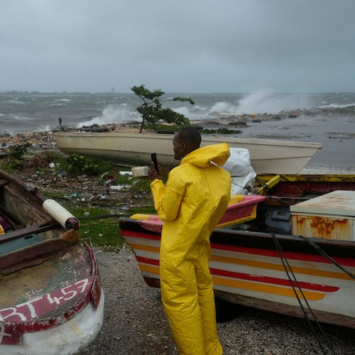 A man watches the coastline in Kingston, Jamaica, as Hurricane Melissa closes in, Tuesday, Oct. 28, 2025. (AP Photo/Matias Delacroix)