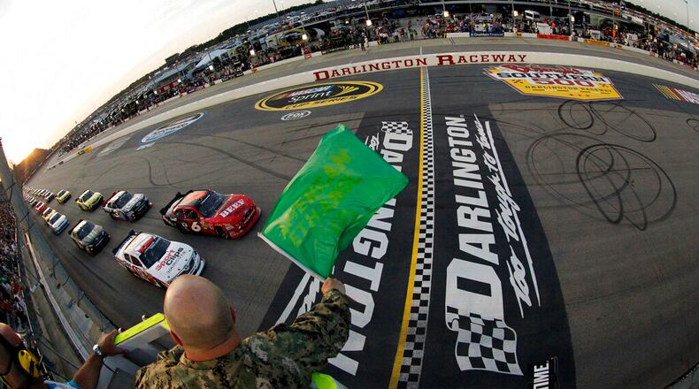 In this May 11, 2012, file photo, drivers take the green flag for the start of the NASCAR Nationwide Series auto race at Darlington Raceway in Darlington, S.C. NASCAR will re-fire the engines moments after mask-clad drivers climb into their cars at Darlington Raceway. The season will resume Sunday May 17, 2020, without spectators and drivers will have no practice before they pull away from pit road for the first time in more than two months. (Tyler Barrick/Pool Photo via AP, File)
