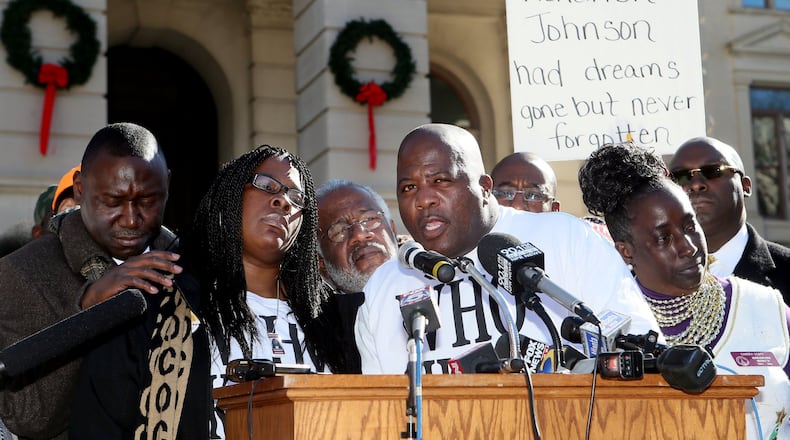 Jackie and Kenny Johnson (center) speak to the crowd during a “Who Killed K.J.” rally for their son Kendrick Johnson in Atlanta in December 2013. PHIL SKINNER / PSKINNER@AJC.COM