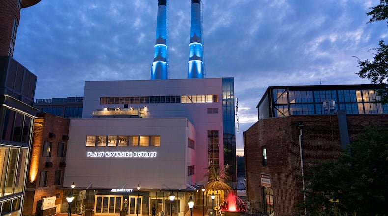 Illuminated 176-foot twin smokestacks light up the newly opened Plant Riverside District entertainment district in Savannah. 
Courtesy of Plant Riverside District