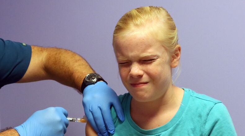 Elizabeth Plyler gets a flu shot. The 10 year-old recently spent four days in ICU after coming down with the flu. Although flu season didn’t officially begin until October, doctors are already diagnosing the virus in metro Atlanta children. BOB ANDRES / BANDRES@AJC.COM