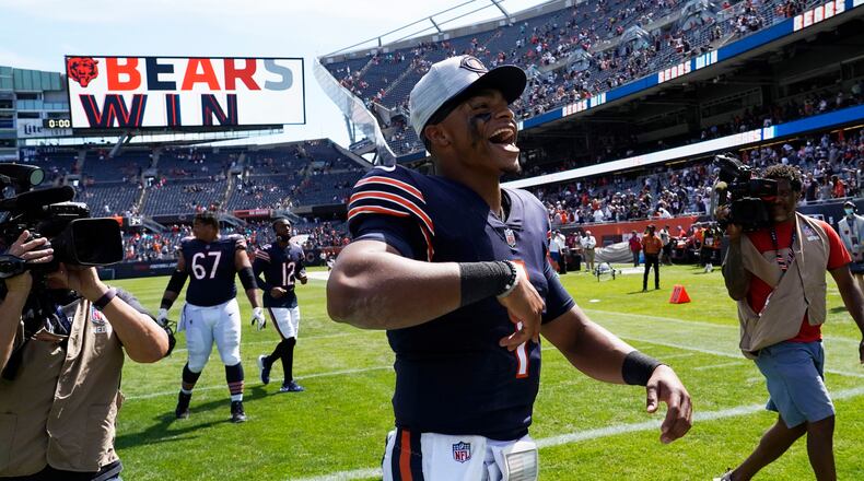 Chicago Bears quarterback Justin Fields (1) celebrates the Bears 20-13 win against the Miami Dolphins during an NFL preseason football game in Chicago, Saturday, Aug.14, 2021. (AP Photo/David Banks)