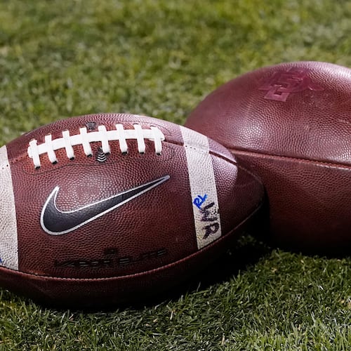 FILE - Footballs rest on the field in the second half of an NCAA college football game Nov. 28, 2020, in Boulder, Colo. (AP Photo/David Zalubowski, File)