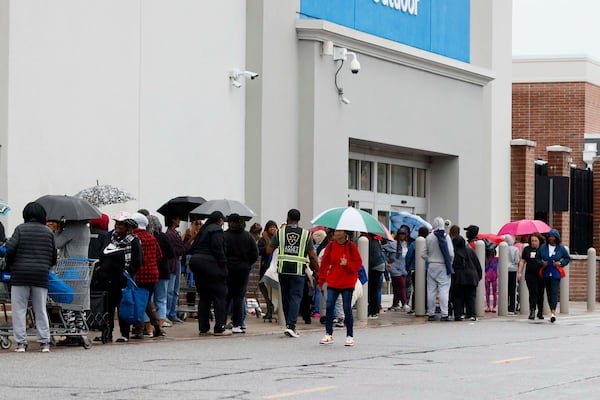 Some people arrived as early as midnight for the “Greens and Things" Thanksgiving giveaway on Tuesday, Nov. 24, 2025. They waited through some rain as well. (Miguel Martinez/AJC)