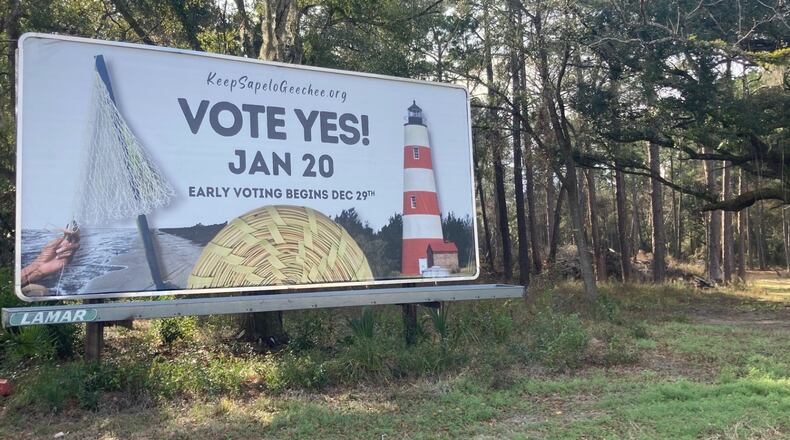 A billboard encourages voters to cast ballots in a special election stands along U.S. 17 in McIntosh County. A referendum seeking to repeal a controversial Sapelo Island zoning ordinance is the only item on the ballot. (Adam Van Brimmer/AJC)