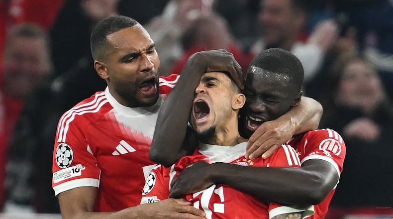 Bayern's Luis Diaz, center, celebrates with Dayot Upamecano right, and Jonathan Tah after scoring his their third goal during the Champions League quarterfinal second leg soccer match between Bayern Munich and Real Madrid in Munich, Germany, Wednesday, April 15, 2026. (Sven Hoppe/dpa via AP)