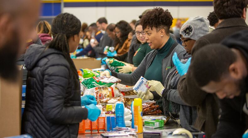A group from Instacart helps sort food & other items in the Product Rescue Center at the Atlanta Community Food Bank in Atlanta. For two weeks each year, CPAs show their competitive side away from the ledger sheets and tax deadlines. The Georgia Accounting Food Fight helps to restock food banks, and this year’s competition raised enough to provide more than 744,000 meals. (Photo by Phil Skinner)
