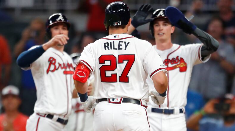 Austin Riley celebrates hitting a grand slam with teammates as he scores in the seventh inning of an MLB game against the Washington Nationals at SunTrust Park on May 29, 2019 in Atlanta, Georgia. (Photo by Todd Kirkland/Getty Images)