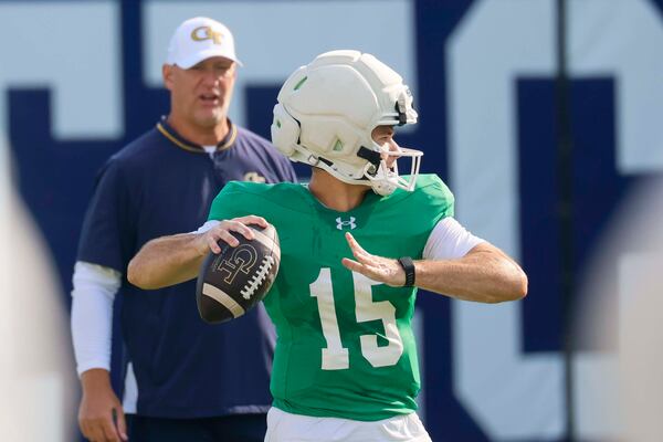Georgia Tech quarterback Alberto Mendoza (15) participates in a drill as co-offensive coordinator Chris Weinke looks on during a practice at Rose Bowl Field and the Mary and John Brock Football Practice Facility on Tuesday, August 18, 2026. (Miguel Martinez/AJC)