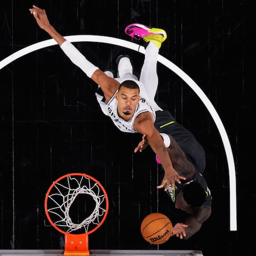 San Antonio Spurs forward Julian Champagnie, right, is blocked by San Antonio Spurs forward Victor Wembanyama, left, as he drives to the basket during the second half in Game 2 of a second-round NBA playoffs basketball series in San Antonio, Wednesday, May 6, 2026. (AP Photo/Eric Gay)