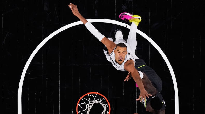 San Antonio Spurs forward Julian Champagnie, right, is blocked by San Antonio Spurs forward Victor Wembanyama, left, as he drives to the basket during the second half in Game 2 of a second-round NBA playoffs basketball series in San Antonio, Wednesday, May 6, 2026. (AP Photo/Eric Gay)
