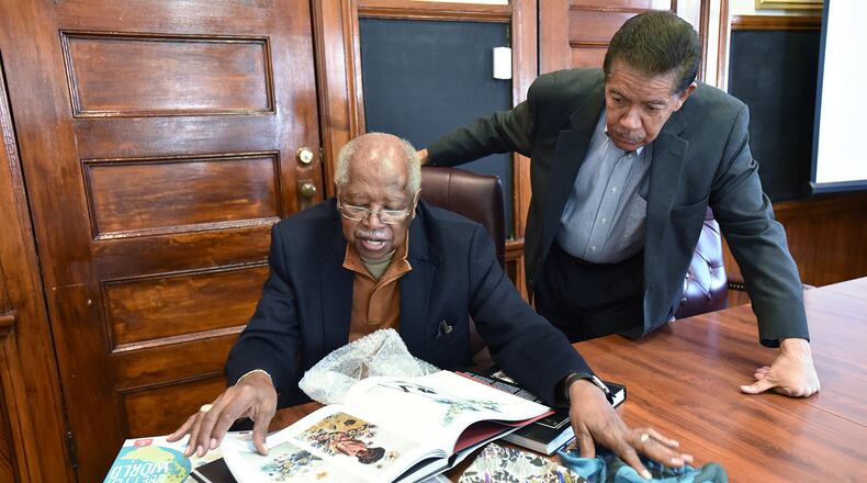 Prominent alumni Leo Twiggs, left, and Cecil Williams look some of their works at Claflin University. “African-Americans, when they give, they like to see results immediately,” said Twiggs, an artist and 1956 graduate of Claflin, and the school’s Distinguished Artist-in-Residence. (HYOSUB SHIN / HSHIN@AJC.COM)