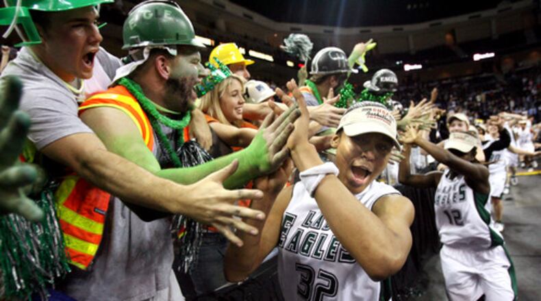 "I enjoy covering Gwinnett high school sports," said AJC photographer Jason Getz. "One thing I enjoy about it is following players several years through their high school career. Two time Girl's Basketball national player of the year Maya Moore was one of those special student/athletes to cover...I've seen Moore lead Collins Hill around the arena after a win and placed myself in front of the student section waiting for her arrival. She came right at me and I snapped this frame."