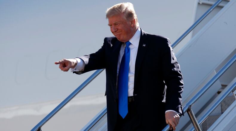 President Donald Trump walks down the steps of Air Force One after landing at Dallas Love Field airport, Wednesday, Oct. 25, 2017, in Dallas. (AP Photo/Evan Vucci)