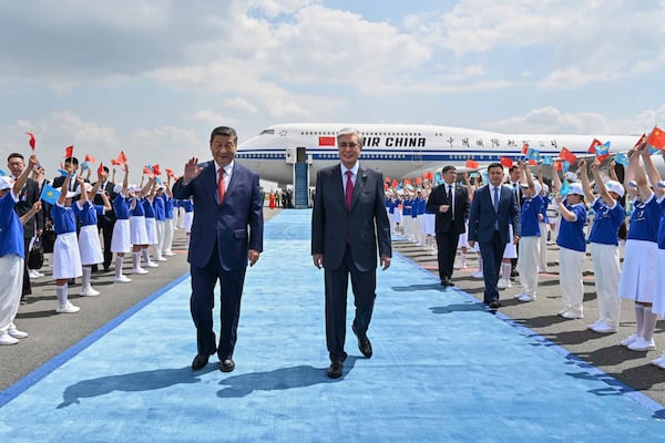 In this photo released by Kazakhstan's Presidential Press Office, Chinese President Xi Jinping, left, walks with Kazakh President Kassym-Jomart Tokayev upon his arrival at an international airport outside Astana, Kazakhstan, on Monday, June 16, 2025. (Kazakhstan's Presidential Press Office via AP)