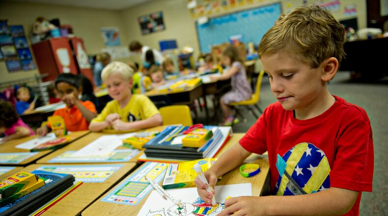 Max Psencik (right) colors a pirate worksheet during the first day of classes at Davis Elementary School in Marietta on Monday, August 4, 2014. Teachers and administrators at the school dressed as pirates for the first day of school. Students in Cobb County and Atlanta public schools headed back to class on Monday for the new school year. JONATHAN PHILLIPS / SPECIAL