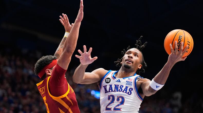 Kansas guard Darryn Peterson (22) shoots over Iowa State forward Joshua Jefferson (5) during the first half of an NCAA college basketball game Tuesday, Jan. 13, 2026, in Lawrence, Kan. (AP Photo/Charlie Riedel)