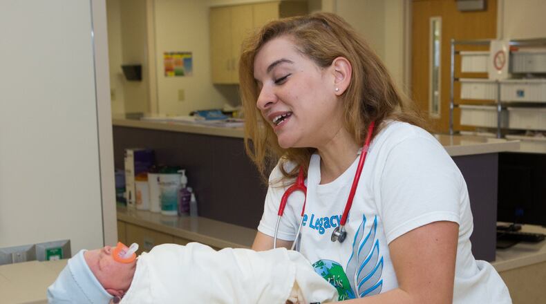 Hanan Waite, of Earth’s Angels, checks on a newborn baby at the Northside Hospital Women’s Center in Atlanta. (Photo by Phil Skinner)