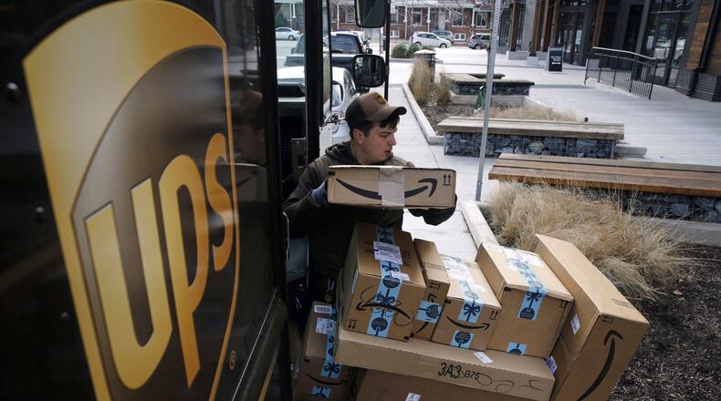 A UPS driver prepares to deliver packages, Wednesday, Dec. 19, 2018, in Baltimore. (AP Photo/Patrick Semansky)