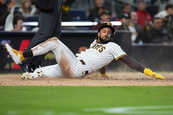 San Diego Padres' Fernando Tatis Jr. scores off a fielder's choice by Xander Bogaerts during the seventh inning of a baseball game against the Cleveland Guardians Tuesday, April 1, 2025, in San Diego. (AP Photo/Gregory Bull)