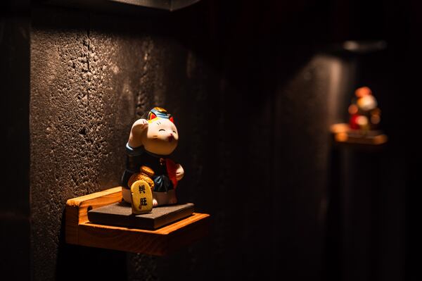 Boy and girl maneki-neko (beckoning cat) figurines welcome guests to the bathrooms at the new Buckhead location of Omakase Table. (Henri Hollis/AJC)