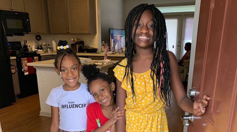 Children who live at a Columbia Residential property pose with their backpacks and school supplies, provided through Columbia Residential's 2020 Backpack and School Supplies Knock-and-Drop giveaway. Courtesy of Columbia Residential