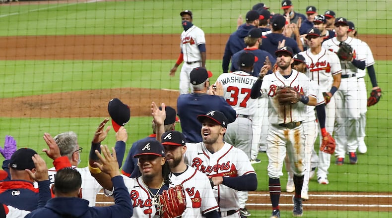 Braves celebrate clinching their third consecutive National League East championship title with a 11-1 victory over the Miami Marlins Tuesday, Sept. 22, 2020, at Truist Park in Atlanta. (Curtis Compton / Curtis.Compton@ajc.com)