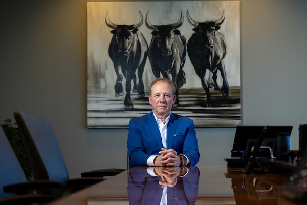 Michael Bull, head of Bull Realty (show in his Sandy Springs office), says the deal with TCN will give his brokers a much wider platform. (Arvin Temkar/AJC)