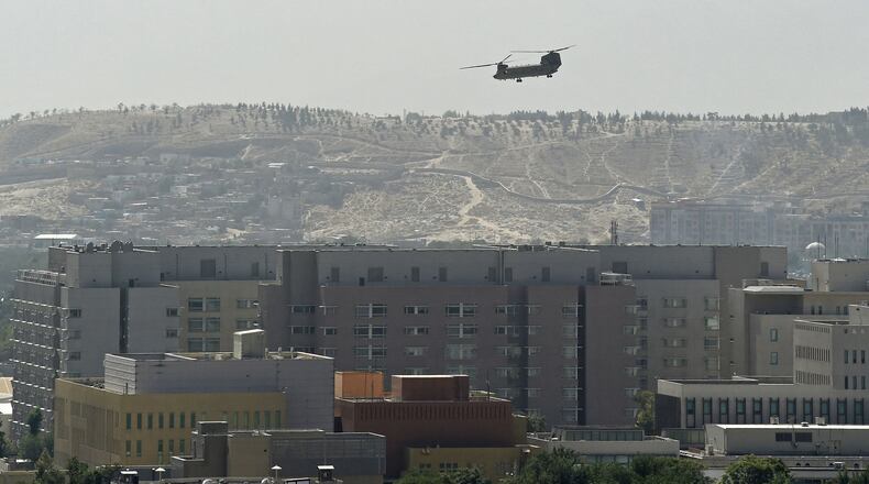 A U.S. military helicopter is pictured Sunday flying above the U.S. Embassy in Kabul, Afghanistan. (Wakil Kohsar/AFP/Getty Images/TNS)