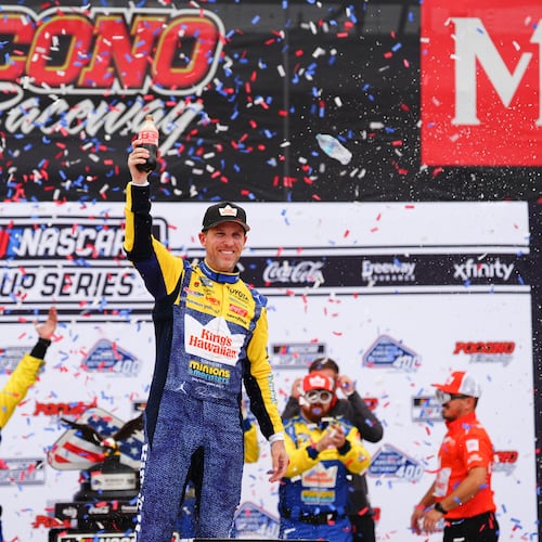Denny Hamlin celebrates in Victory Lane after winning a NASCAR Cup Series auto race at Pocono Raceway, Sunday, June 14, 2026, in Long Pond, Pa. (AP Photo/Derik Hamilton)