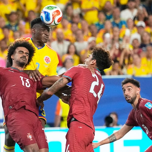 Colombia's Jhon Lucumi (3) leaps above Portugal's Renato Veiga (13) and Samu Costa (24) to head the ball during the World Cup Group K soccer match between Colombia and Portugal in Miami Gardens, Fla., Saturday, June 27, 2026. (AP Photo/Rebecca Blackwell)