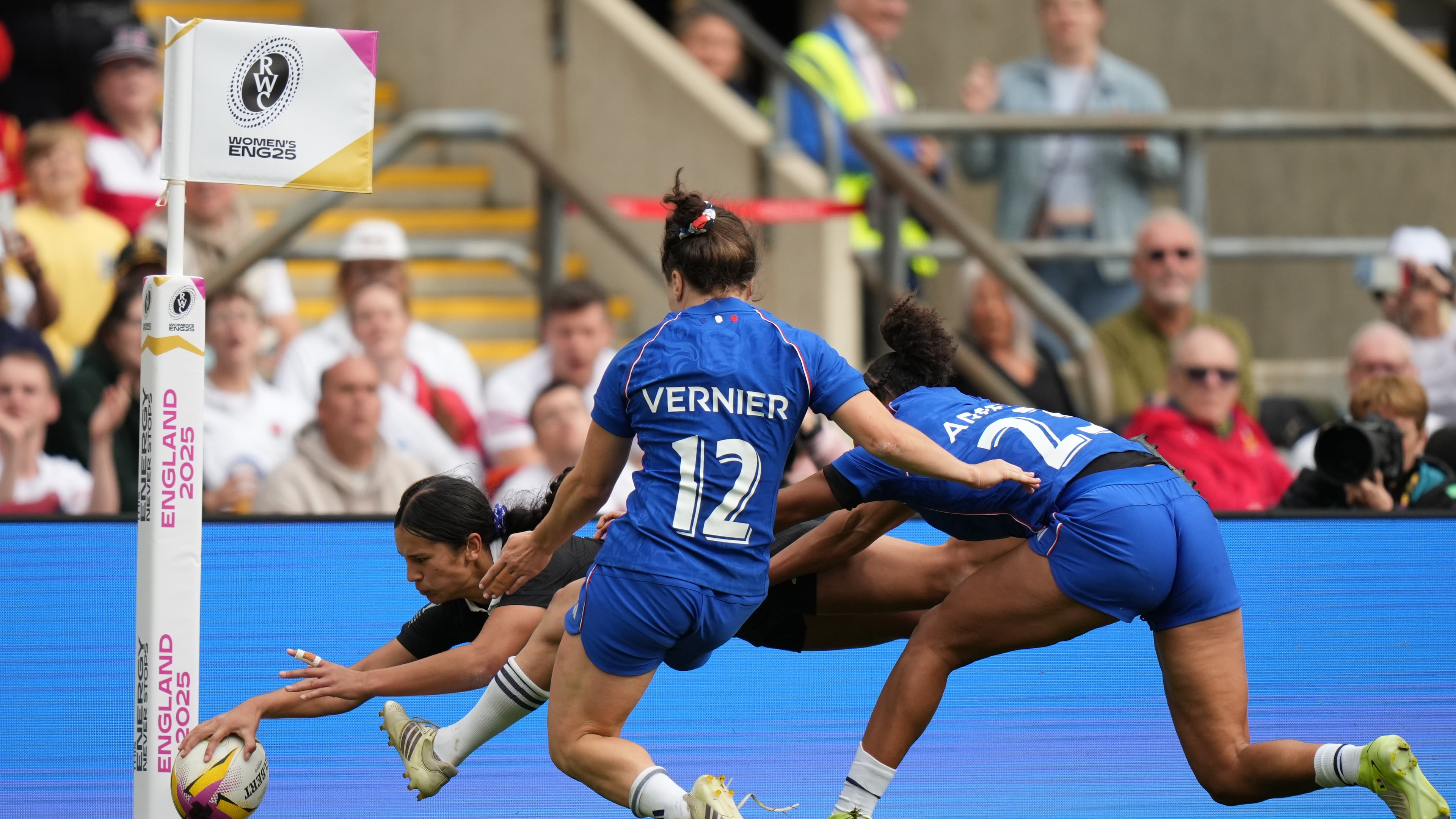New Zealand's Braxton Sorensen-McGee, left, scores a try past Gaby Vernier of France, center and Kelly Arbey of France, right, during the Women's Rugby World Cup bronze match between New Zealand and France at the Allianz Stadium, Twickenham, London, Saturday, Sept. 27, 2025. (AP Photo/Alastair Grant)