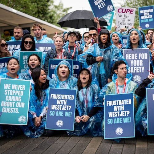 WestJet flight attendants strike at Vancouver International Airport in Richmond, British Columbia, Sunday, Aug. 2, 2026. (Ethan Cairns/The Canadian Press via AP)