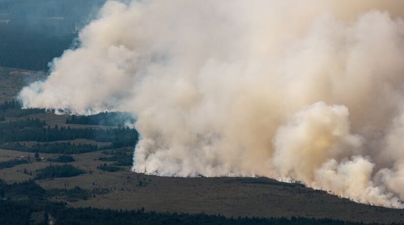 Smoke from a massive wildfire in Belgium's Hohes Venn region is seen from Germany, Sunday, Aug. 16, 2026. (Christoph Reichwein/dpa via AP)