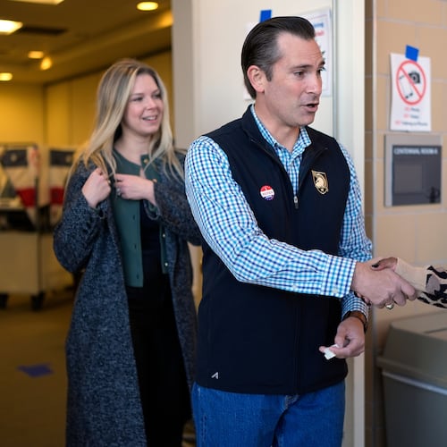 Republican congressional candidate Matt Van Epps, center, and his wife Meg Wrather, left, greet a poll worker after casting their ballots at an early voting site in the special election for the seventh district, Wednesday, Nov. 12, 2025, in Nashville, Tenn. (AP Photo/George Walker IV)