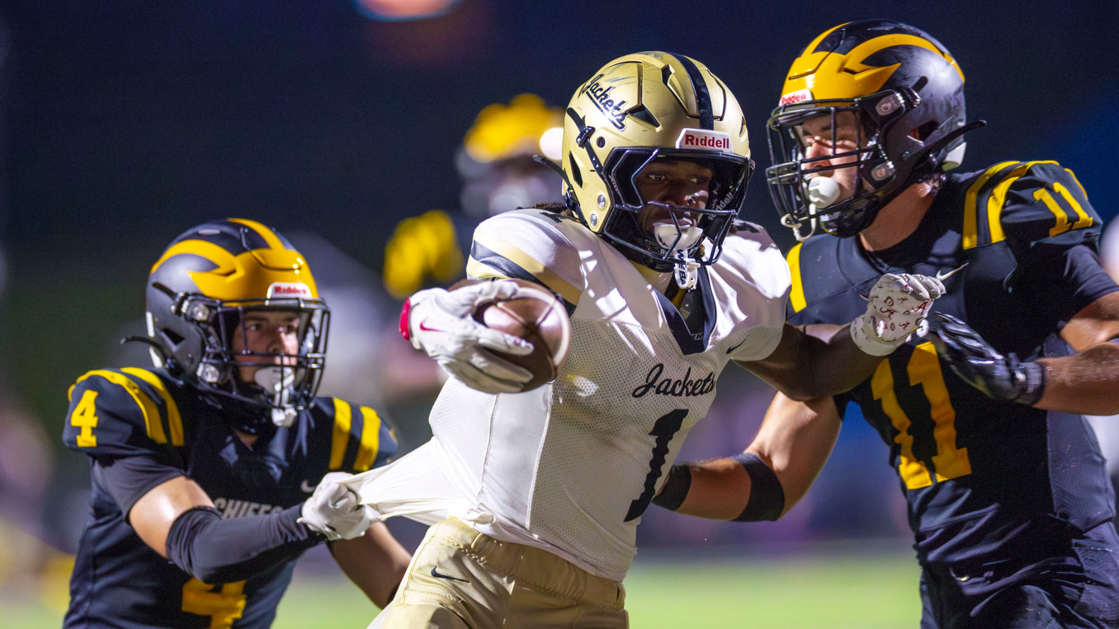 Sprayberry cornerback Jorden Edmonds (center) gets pulled by two Sequoyah players while scoring a touchdown during the first half against Sequoyah at Skip Pope Stadium in Canton, on Friday, Sept. 12, 2025. (Oscar Guevara Saenz for the AJC)