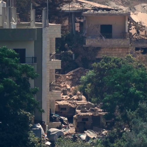 Israeli military vehicles, left, are seen stationed among homes in the village of Zawtar al-Sharqiyah, occupied by Israeli forces, is seen from the southern village of Zawtar al-Gharbieh, Lebanon, Wednesday, Aug. 5, 2026. (AP Photo/Mohammed Zaatari)