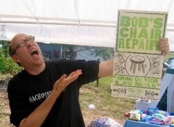 George Lowe holds a promotional poster he designed during the mid-1990s at the Hewell Pottery Turning and Burning Festival in Gillsville, Ga. (Courtesy of Jack Regan)