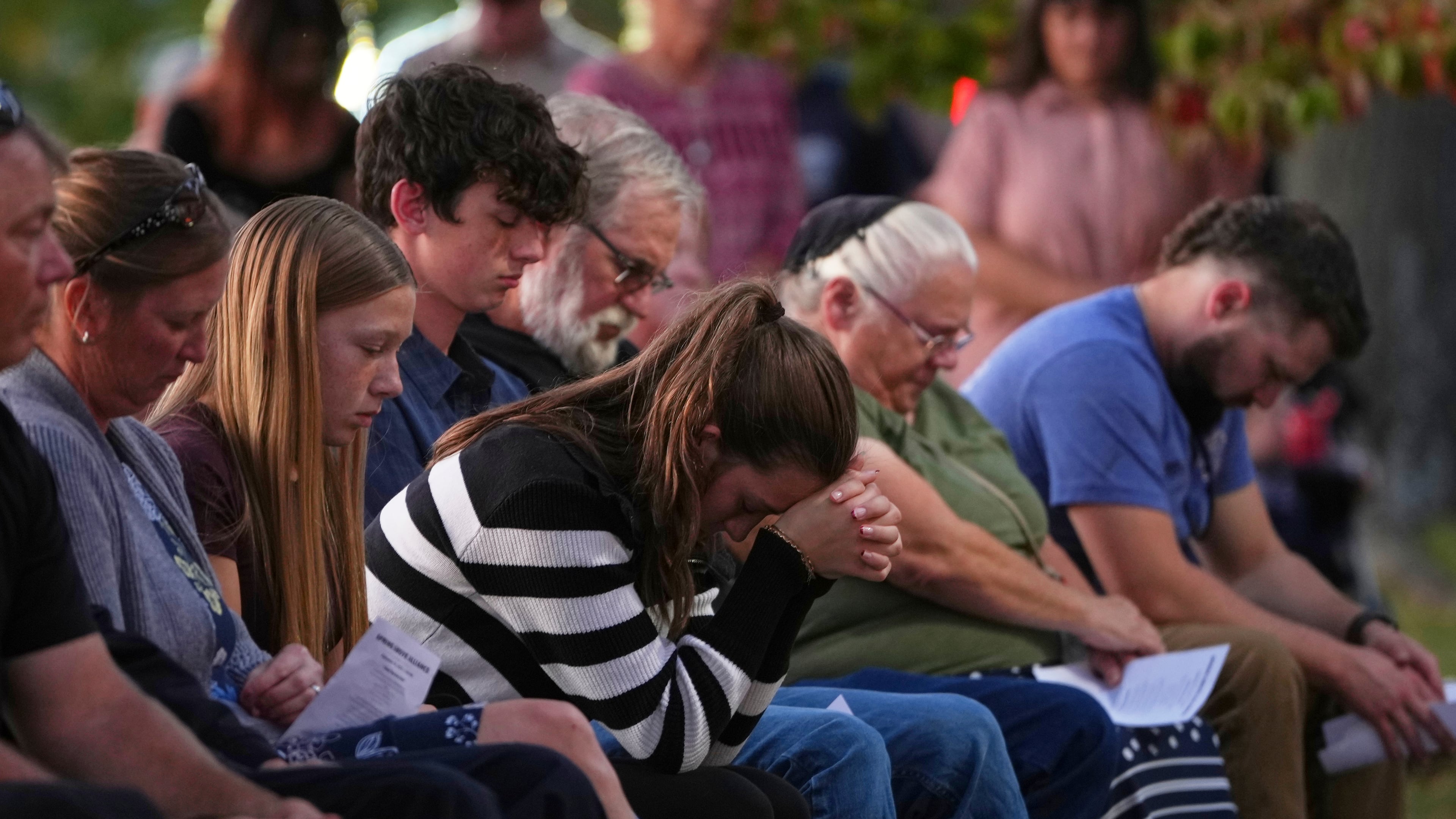 Attendees react during a vigil at Spring Grove Alliance church Thursday, Sept. 18, 2025, in Spring Grove, Pa., after multiple police officers were shot and killed. (AP Photo/Matt Slocum)