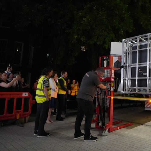 Workers unload a box that contains the Bayeux Tapestry out of a truck at the British Museum in London, Friday, July 10, 2026. (AP Photo/Kwiyeon Ha)