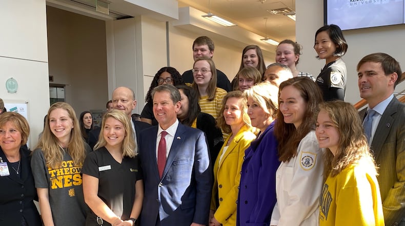Georgia Gov. Brian Kemp (center in the front row) is joined by some Kennesaw State University students during a visit to the Kennesaw campus in February. Kemp has allocated $11.5 million to the University System of Georgia, which includes KSU, for student mental health programs. ERIC STIRGUS/ESTIRGUS@AJC.COM
