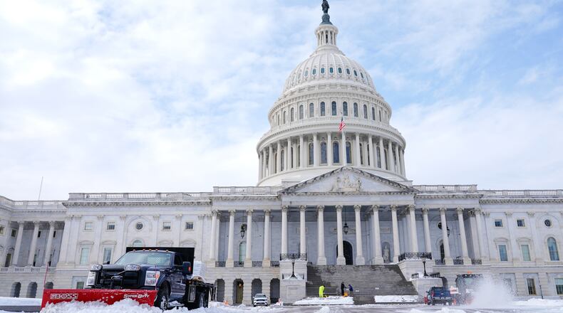 Workers clear the Capitol grounds after a snowstorm Monday, Jan. 26, 2026, in Washington. (AP Photo/Mariam Zuhaib)