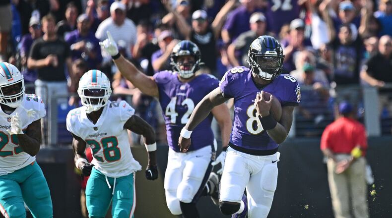 Baltimore Ravens quarterback Lamar Jackson, right, runs for a 79-yard touchdown against the Miami Dolphins on Sept. 18, 2022, at M&T Bank Stadium in Baltimore. (Kenneth K. Lam/The Baltimore Sun/TNS)