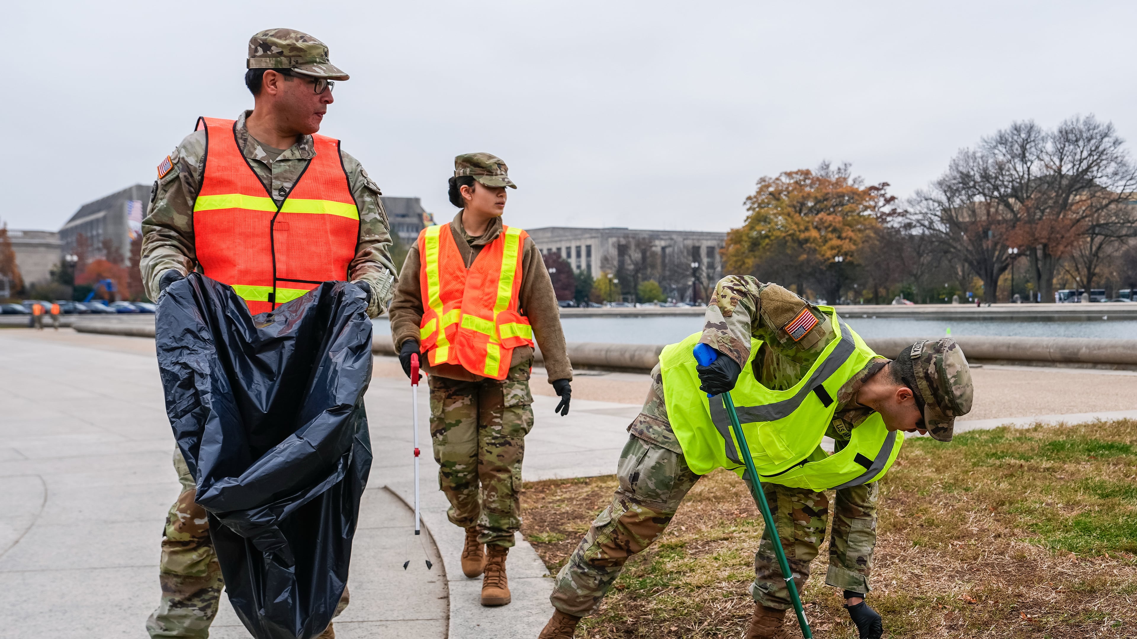 Members of the District of Columbia National Guard pick up trash by the Capitol reflecting pool, Friday, Nov. 21, 2025, in Washington. (AP Photo/Julia Demaree Nikhinson)