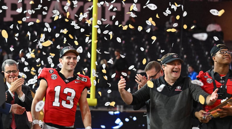 Georgia quarterback Stetson Bennett (13) and coach Kirby Smart celebrate their victory during the 2023 College Football Playoff National Championship game at SoFi Stadium, Monday, Jan. 9, 2023, in Inglewood, California. (Hyosub Shin/The Atlanta Journal-Constitution/TNS)