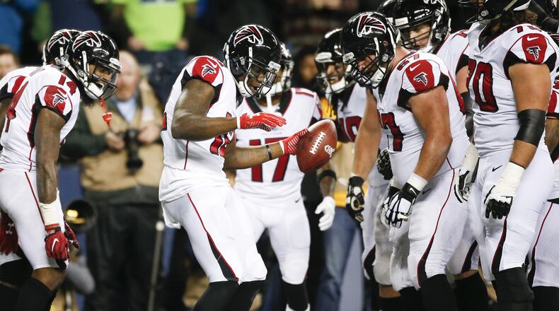 Falcons wide receiver Mohamed Sanu (12) celebrates after a touchdown that gave his team a 14-0 lead against the Seattle Seahawks in the first quarter at CenturyLink Field in Seattle.