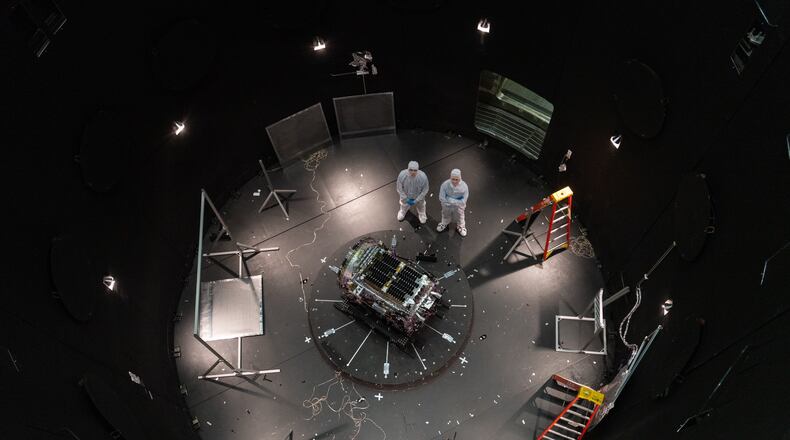 This photo provided by NASA shows Kieran Wilson, LINK’s principal investigator, and Hunter Robertson, a space systems engineer, both at Katalyst Space, standing next to their spacecraft inside the SES (Space Environment Simulator) at NASA’s Goddard Space Flight Center in Greenbelt, Md., April 17, 2026, ahead of thermal vacuum testing. (Sophia Roberts/NASA via AP)